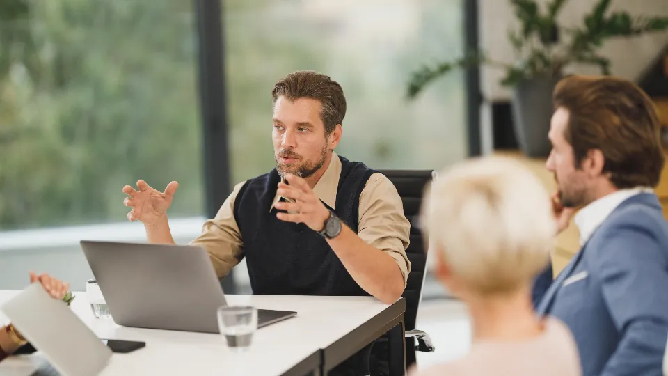Business team discussing a plan around a laptop