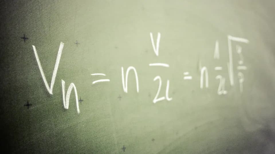 Physics formula for wave harmonics written in chalk