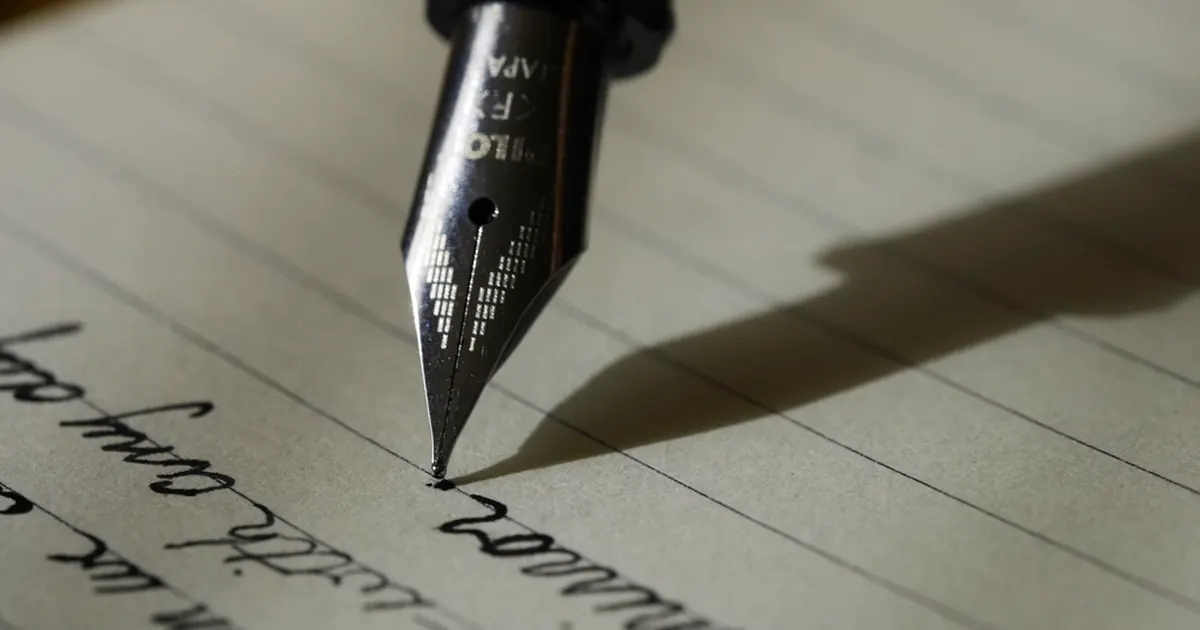 Fountain pen writing an essay on lined paper